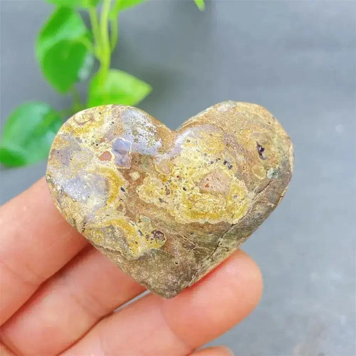 Green Cherry Agate Heart Crystal: Polished, heart-shaped stone with earthy green and brown tones, promoting emotional balance.