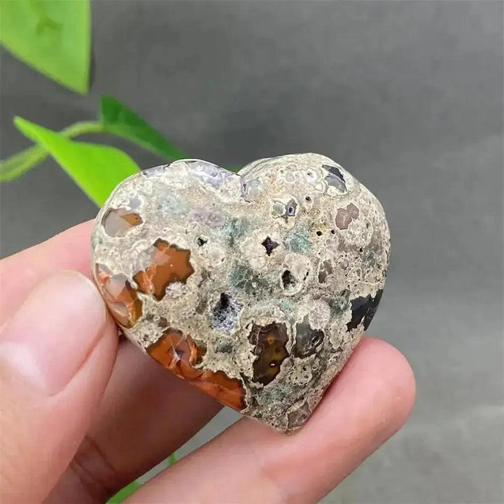 Green Cherry Agate Heart Crystal: unique, soothing heart-shaped stone with soft green and cherry-like inclusions.