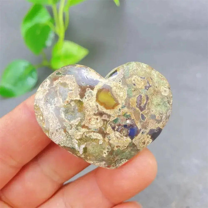 Green Cherry Agate Heart Crystal: unique polished stone with soft green tones, cherry inclusions, and organic patterns.