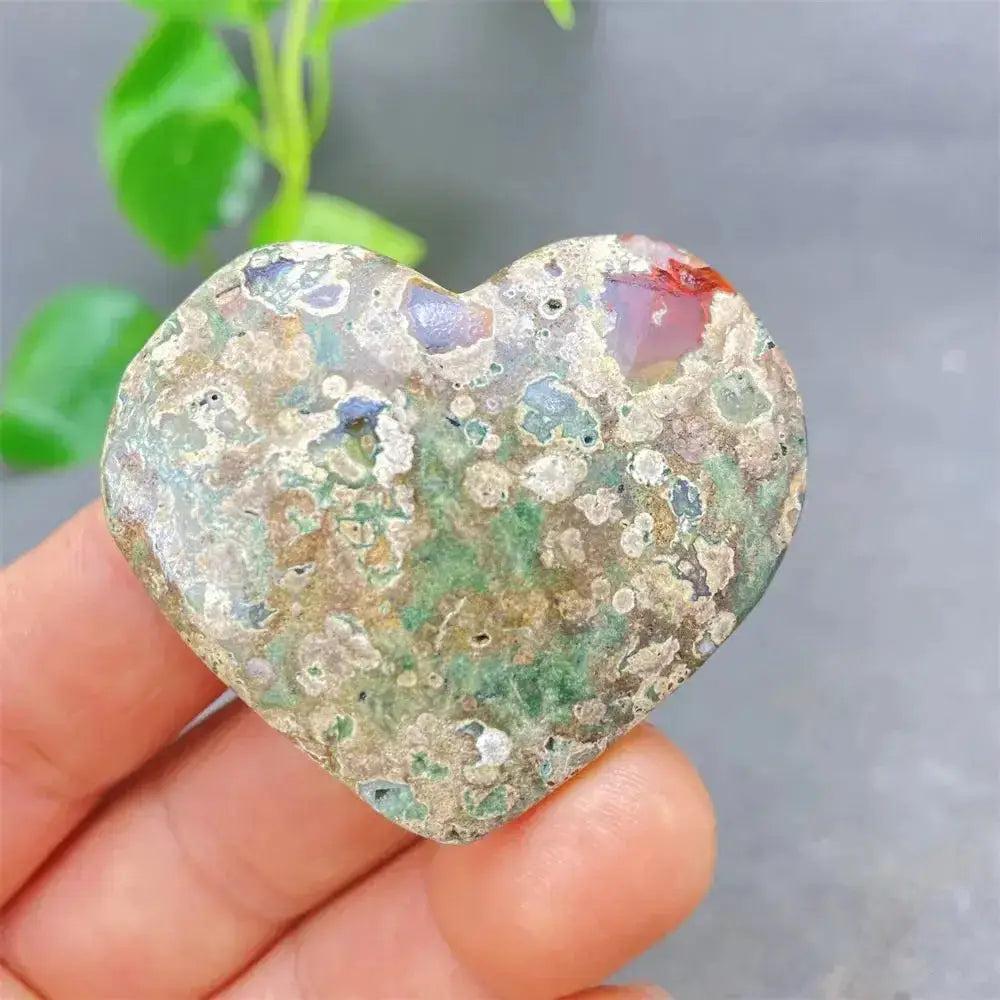 Green Cherry Agate Heart Crystal: Polished heart-shaped stone with soft green tones, subtle cherry-like inclusions, and organic patterns.