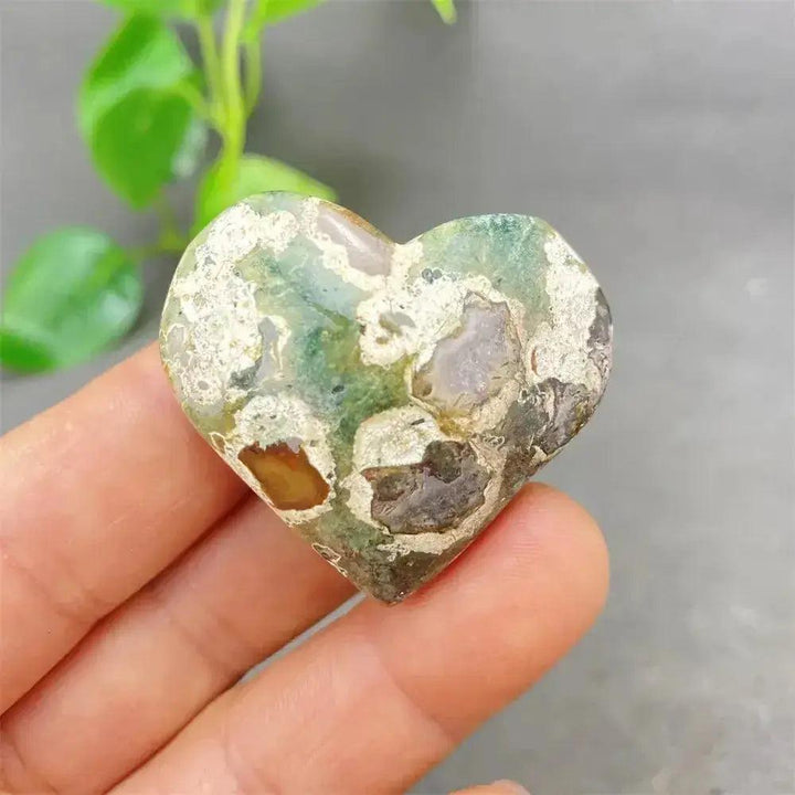 Green Cherry Agate Heart Crystal: Smooth, polished heart-shaped stone with soft green tones and cherry-like inclusions.