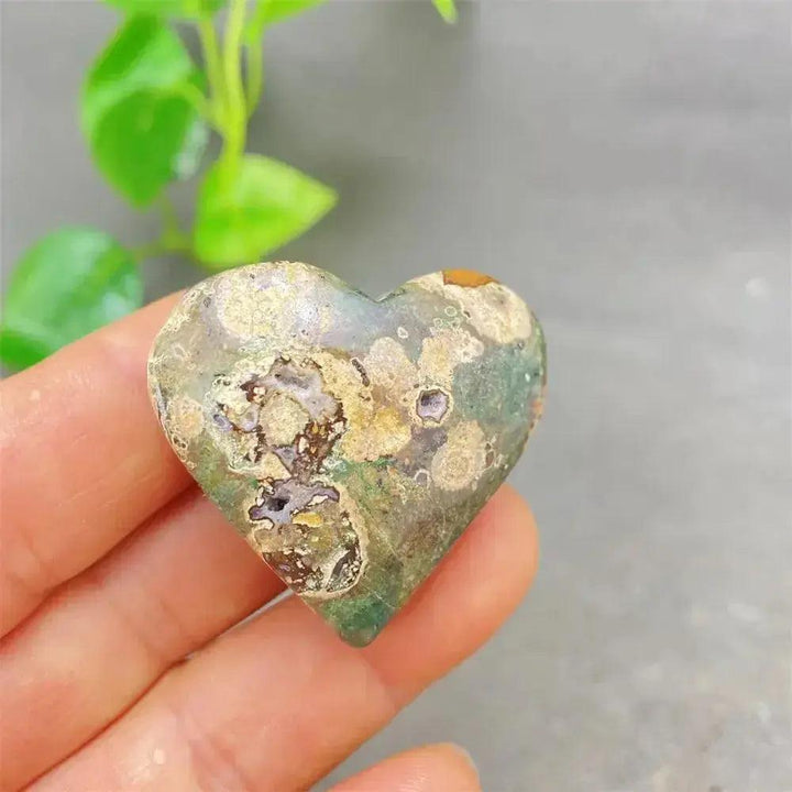 Green Cherry Agate Heart Crystal: Smooth, polished heart-shaped stone with soft green tones and cherry-like inclusions.