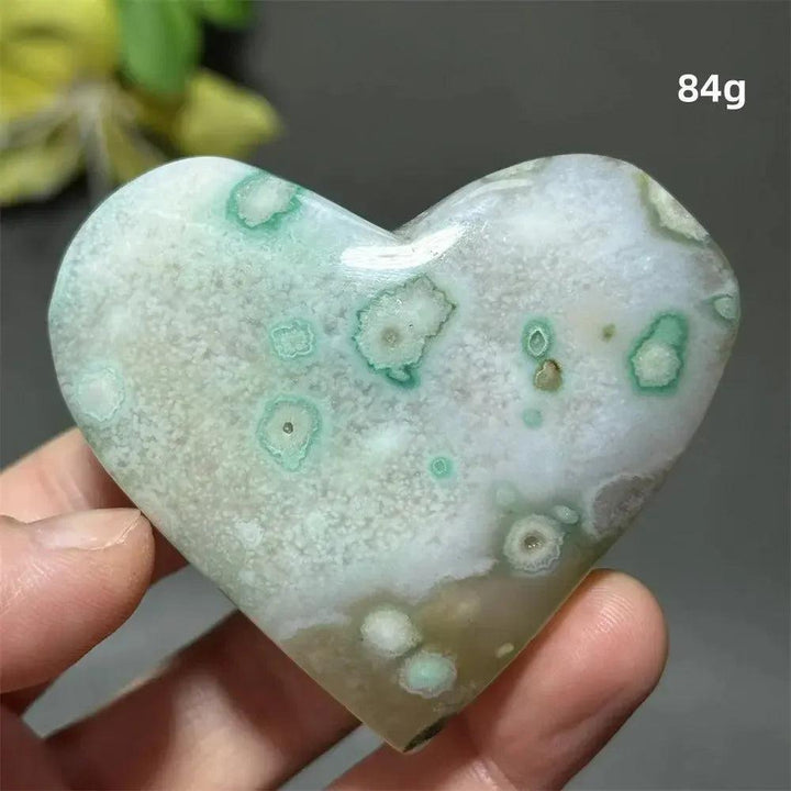 Green Cherry Agate Crystal Heart: Polished, heart-shaped stone with mint green and white flower-like patterns for growth and self-love.