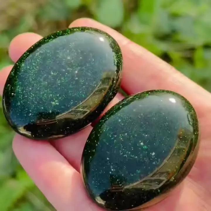 Polished green sandstone palm stones with sparkling glittery flecks for meditation and luck.