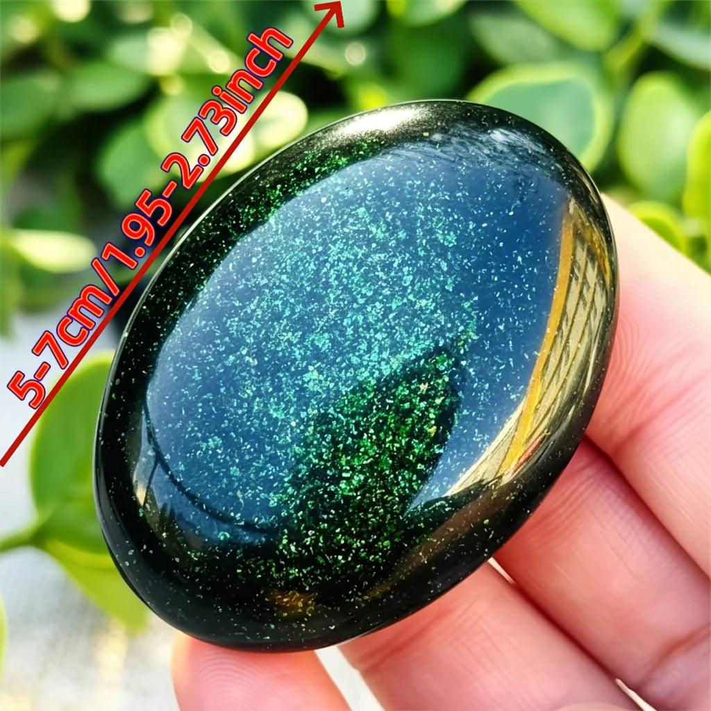 Polished green sandstone palm stone with sparkling metallic flecks for meditation and luck.