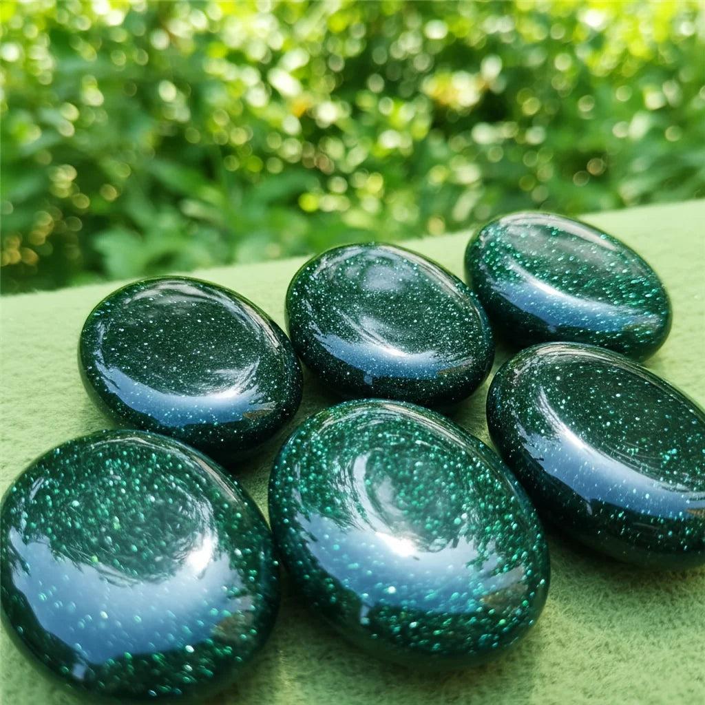 Polished green sandstone palm stones with sparkling glittery flecks for meditation and luck.
