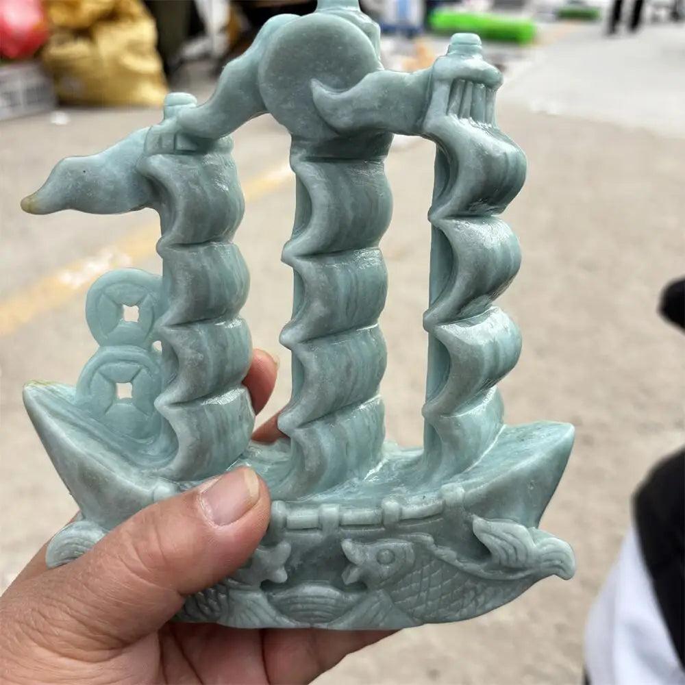 Hand-carved green jade sailboat statue, a symbol of prosperity and Heart Chakra harmony for your desk or altar.
