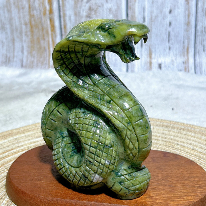 Green Jasper Crystal Carved Striking Cobra, a polished, grounding serpent sculpture for heart and root chakra healing.