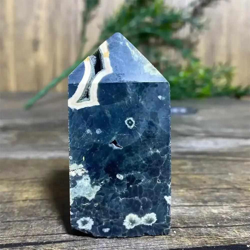 Polished Green Ocean Jasper tower featuring deep green tones, creamy orbs, and a unique crystal point for heart chakra calm.