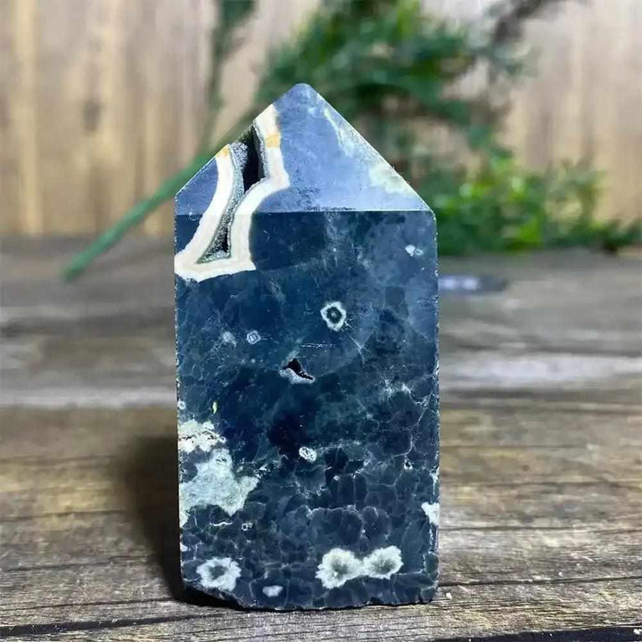 Polished Green Ocean Jasper tower featuring deep green tones, creamy orbs, and a unique crystal point for heart chakra calm.