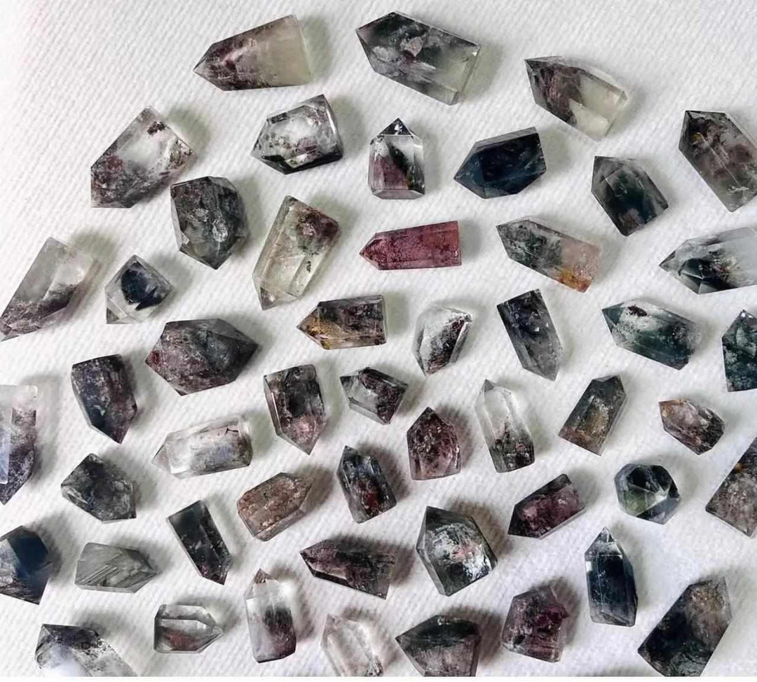 Green Phantom Garden Quartz points featuring mossy inclusions and clear natural crystals for heart chakra healing.