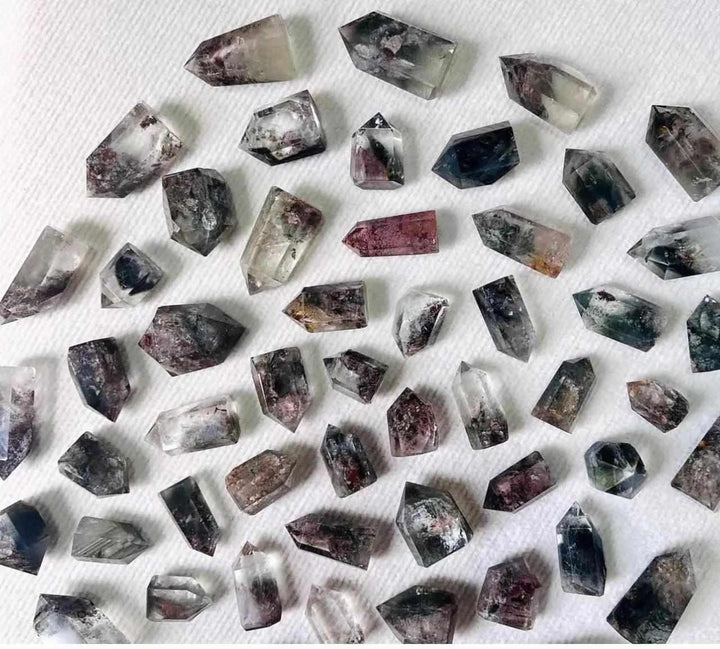 Green Phantom Garden Quartz points featuring mossy inclusions and clear natural crystals for heart chakra healing.