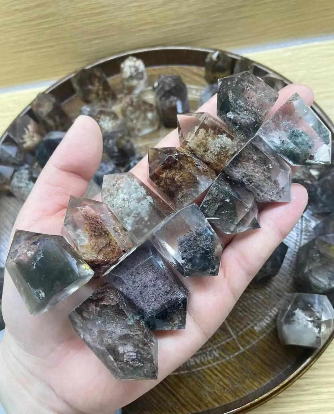 Handheld Green Phantom Garden Quartz points featuring mossy inclusions and clear crystal towers for healing grids.