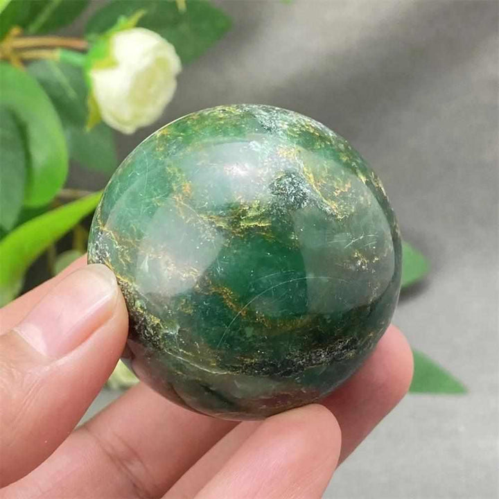 Glossy Green Verdite sphere with rich deep green tones and natural grounding energy held in hand for meditation.