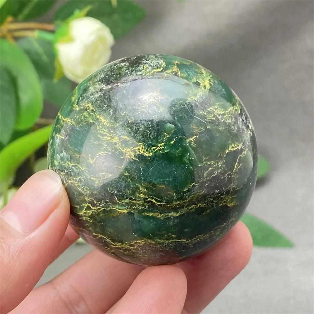 Polished Green Verdite sphere with deep green tones and golden veining, perfect for heart chakra grounding and meditation.