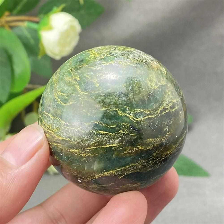 Glossy Green Verdite sphere with deep forest tones and golden veining, perfect for grounding and heart chakra meditation.