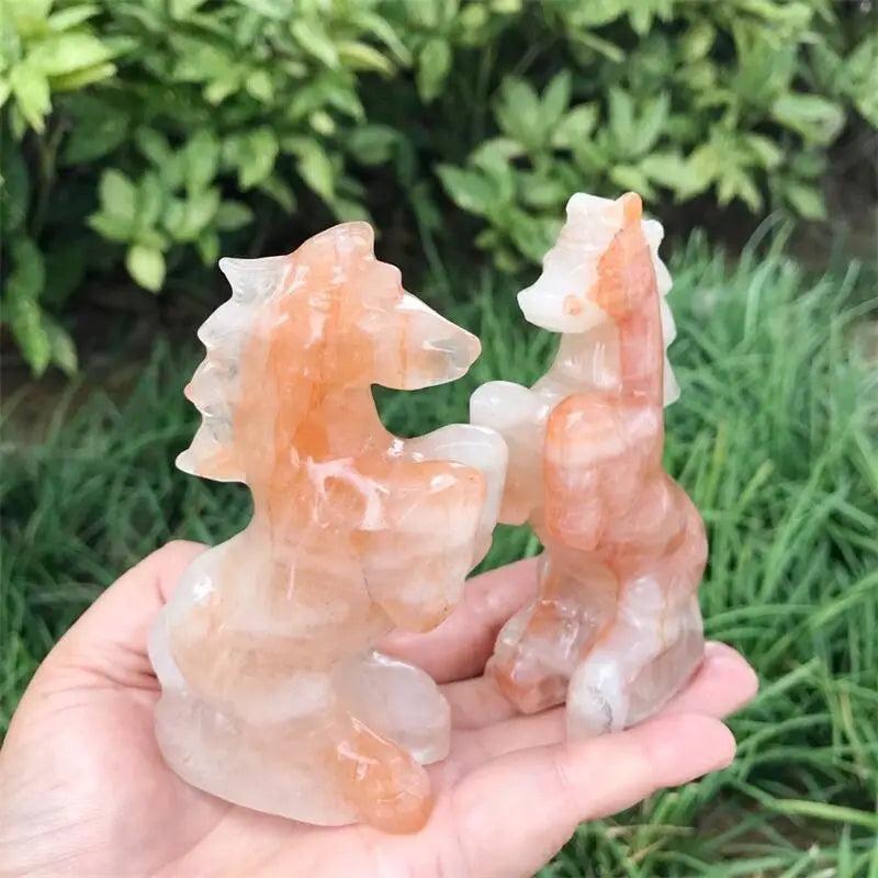 Hand-carved Hematoid Fire Quartz horse sculptures featuring fiery red and orange hematite inclusions for grounded energy.