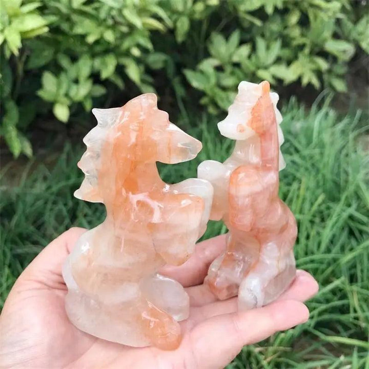 Hand-carved Hematoid Fire Quartz horse sculptures featuring fiery red and orange hematite inclusions for grounded energy.