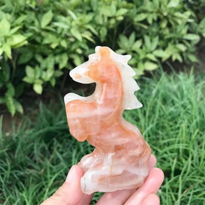 Hand-carved Hematoid Fire Quartz horse sculpture featuring fiery red and orange hematite inclusions for grounded energy.