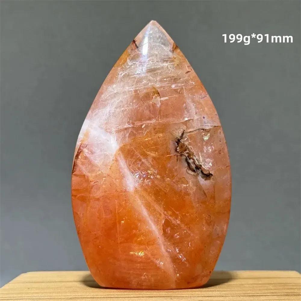 Hematoid Fire Quartz freeform torch from Crystal Destiny, showcasing vibrant red, orange, and gold inclusions.