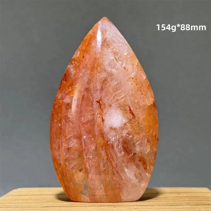 Hematoid Fire Quartz freeform torch from Crystal Destiny, showing red, orange, and gold mineral inclusions.