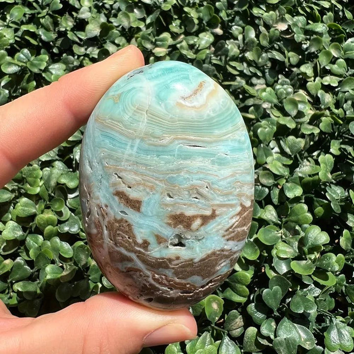 Polished blue and brown Hemimorphite Crystal Palm Stone for throat chakra healing and peace.
