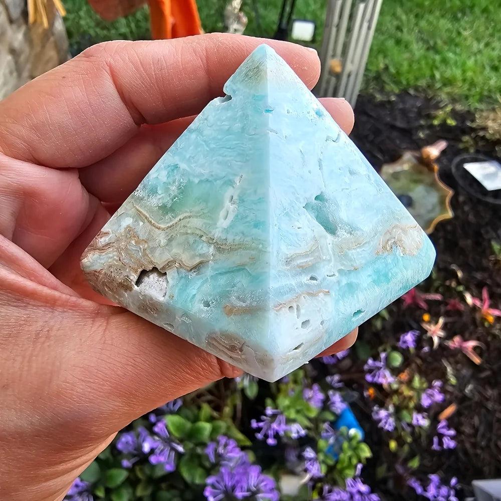 Sky blue Hemimorphite Crystal Pyramid for healing and peace, held in hand.