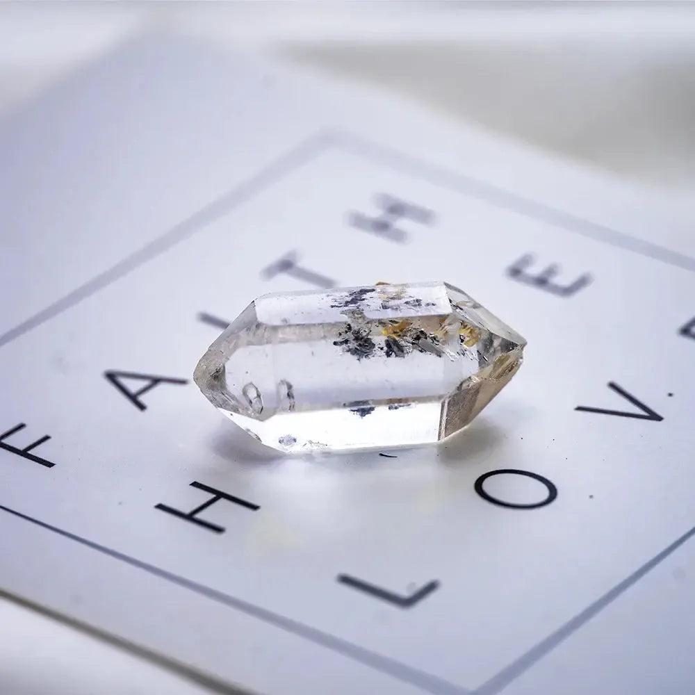 Clear, double-terminated Herkimer Diamond quartz crystal by Crystal Destiny, showcasing natural facets and inclusions.
