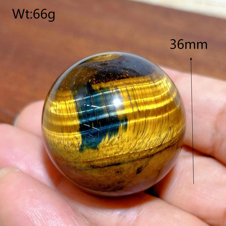 36mm Blue and Yellow Tiger Eye crystal sphere, a polished healing stone with flashy chatoyancy for home decor and energy.
