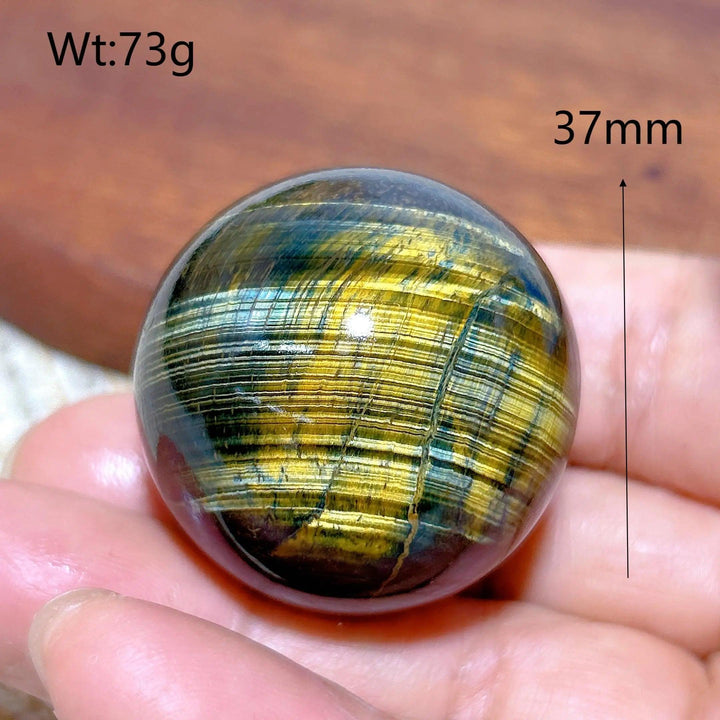 37mm blue and yellow Tiger Eye crystal sphere, a polished healing stone with flashy chatoyancy for home decor and energy.