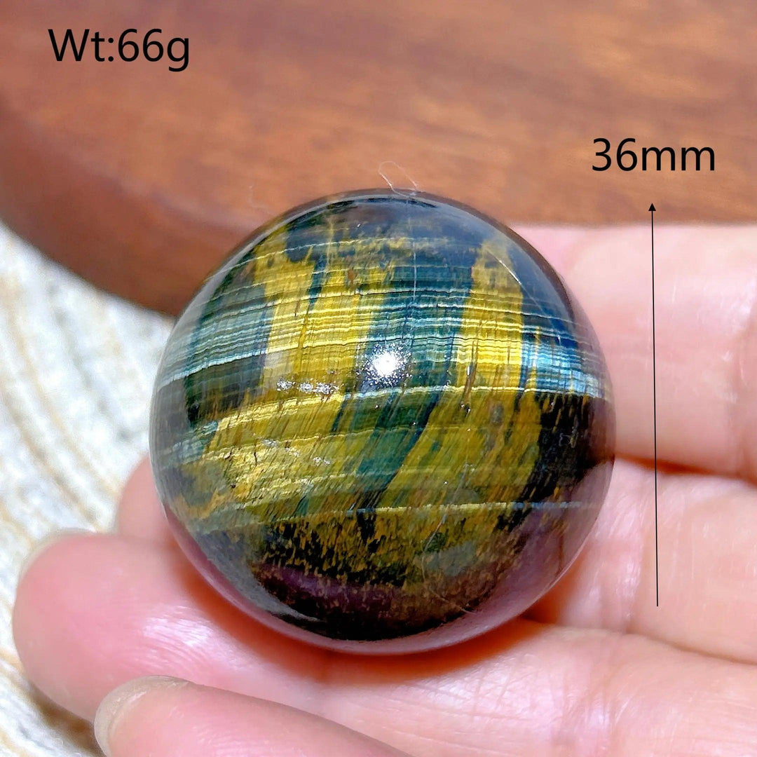36mm Blue and Yellow Tiger Eye crystal sphere, a polished healing stone with flashy, natural energy for home decor.