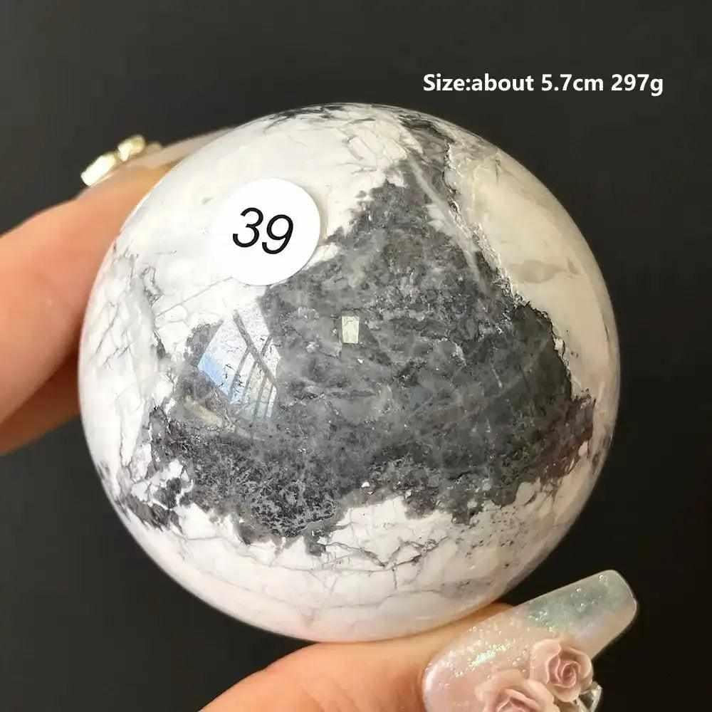 Polished Howlite sphere number 39, featuring creamy white stone with bold gray veining for calm, balanced energy.