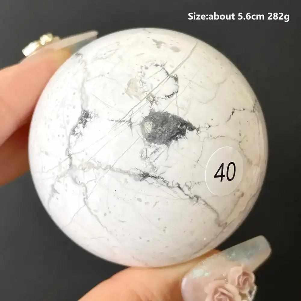 Polished 5.6cm Howlite sphere number 40, featuring creamy white stone with delicate gray veining for calm and balance.
