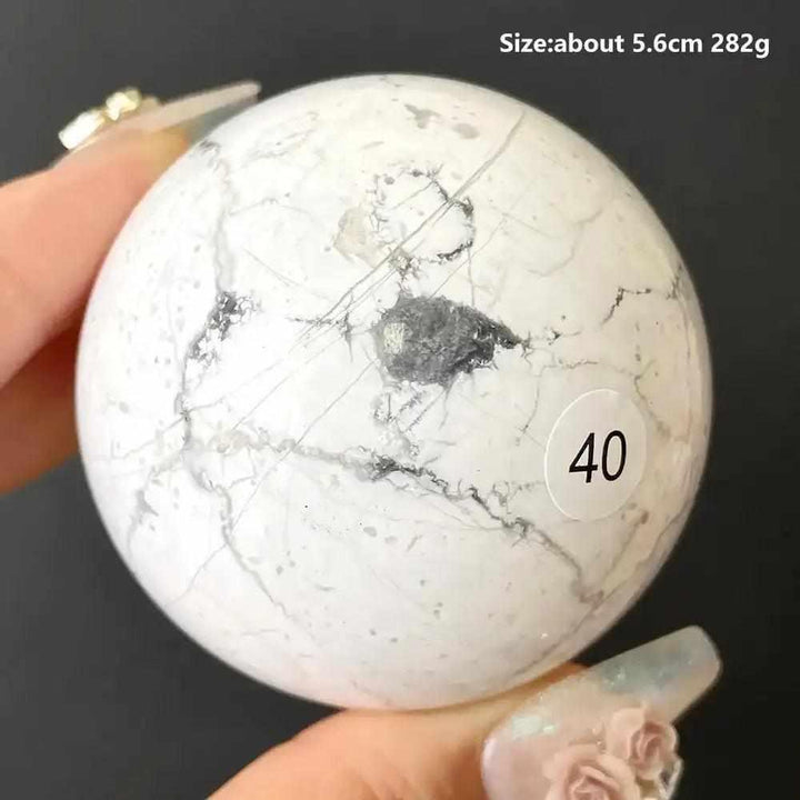 Polished 5.6cm Howlite sphere number 40, featuring creamy white stone with delicate gray veining for calm and balance.