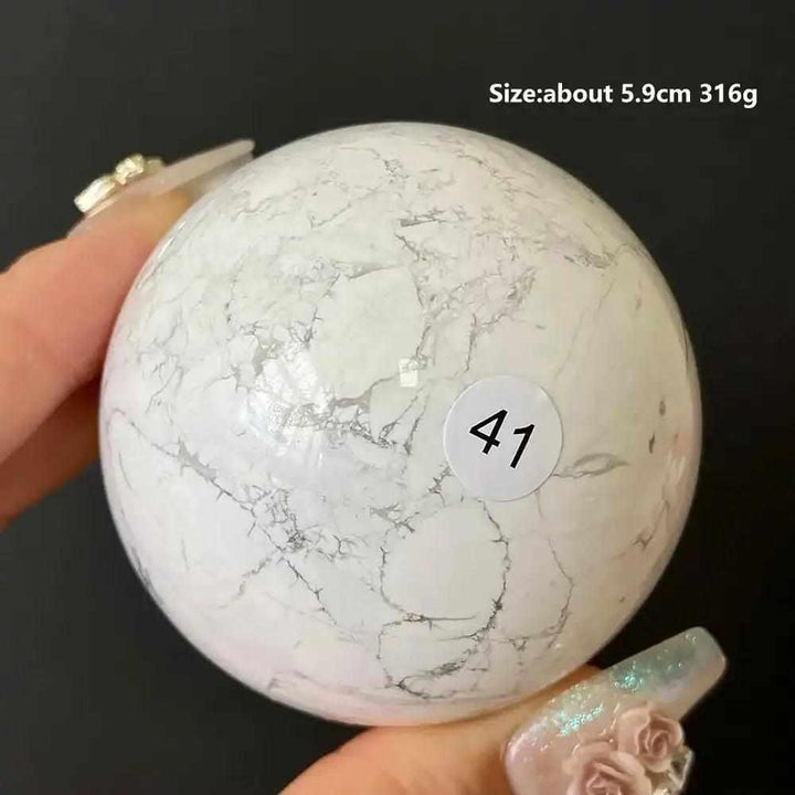 Polished 5.9cm Howlite sphere #41, featuring creamy white stone with delicate gray veining for calm and Crown Chakra balance.
