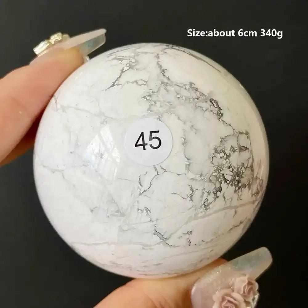 Polished 6cm Howlite sphere number 45, featuring creamy white stone with delicate gray veining for calm and balance.