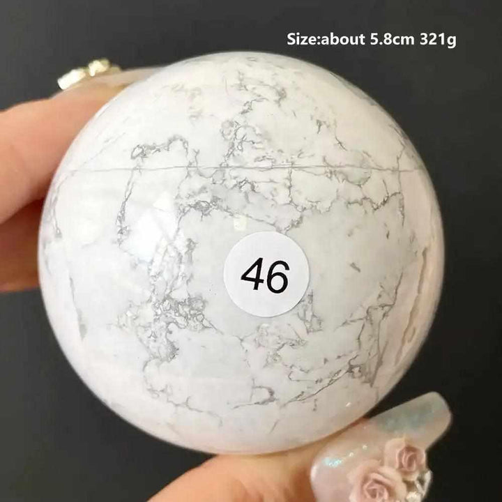 Polished 5.8cm Howlite sphere number 46, featuring creamy white stone with delicate gray veining for calm and balance.