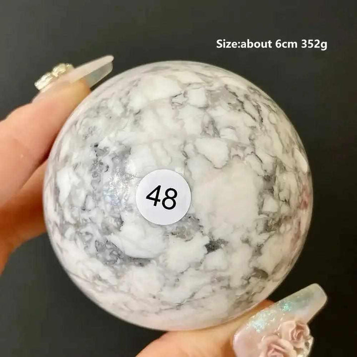 Polished 6cm Howlite sphere, style 48, featuring creamy white stone with intricate gray veining for calm and balance.