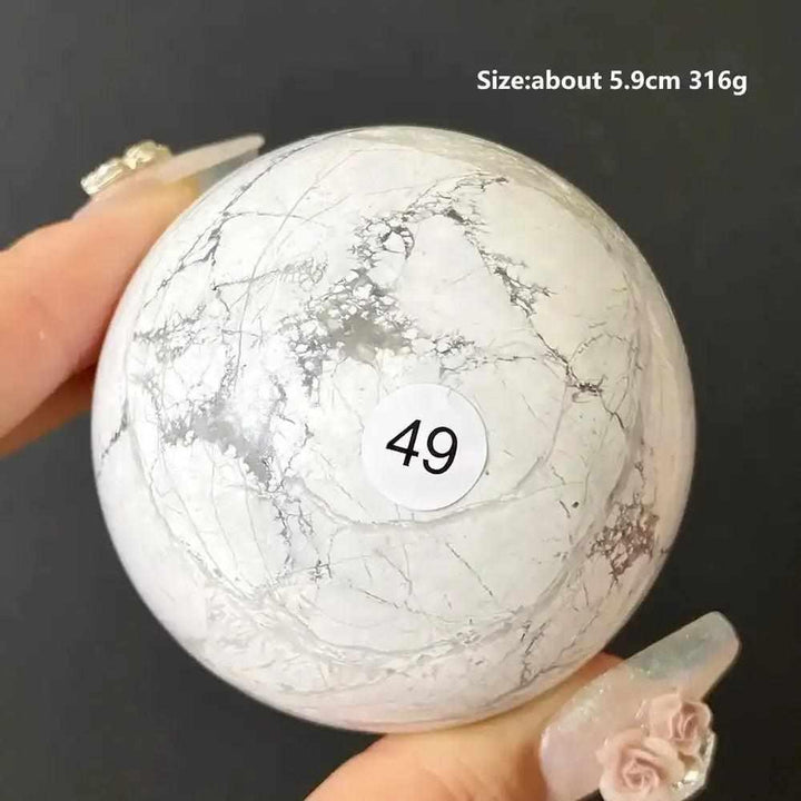 Polished Howlite sphere number 49, a creamy white stone with delicate gray veining for calming Crown Chakra energy.
