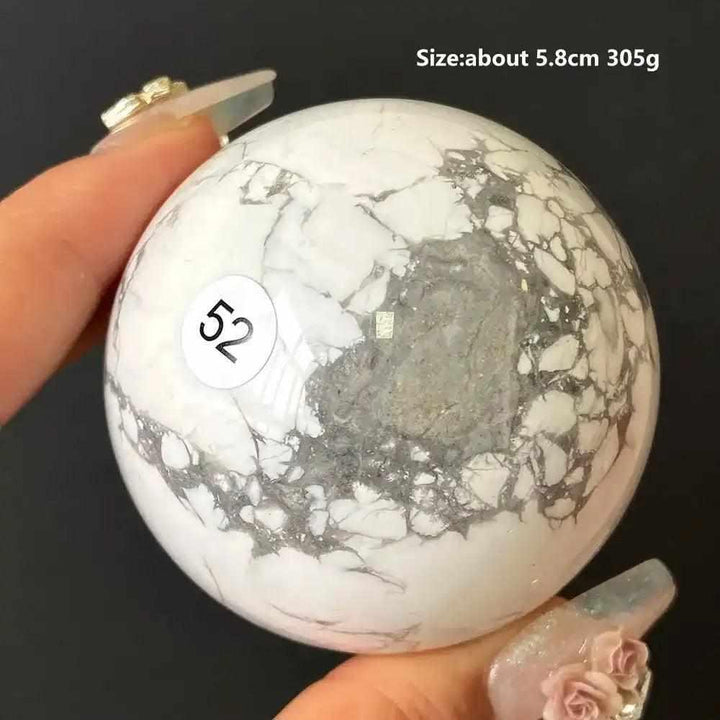 Polished 5.8cm Howlite sphere number 52, featuring creamy white stone with striking gray veining for calming meditation.