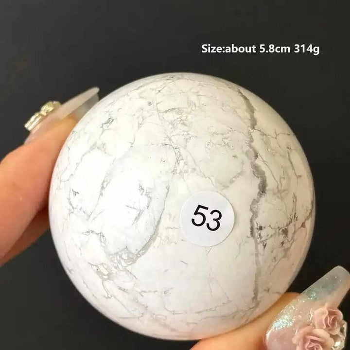 Polished 5.8cm Howlite sphere number 53, featuring creamy white stone with delicate gray veining for calm and balance.