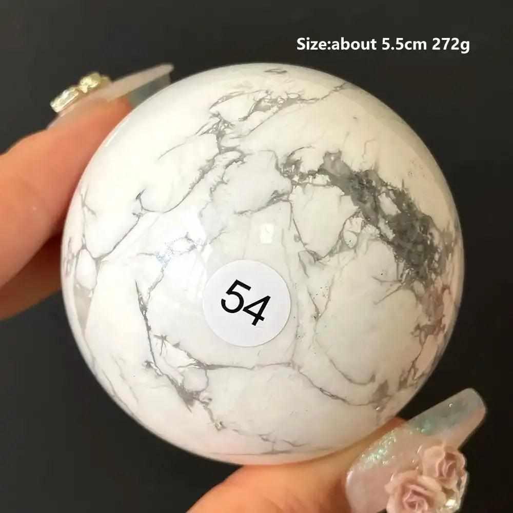 Polished 5.5cm Howlite sphere #54 with creamy white stone, delicate gray veining, and calming Crown Chakra energy.