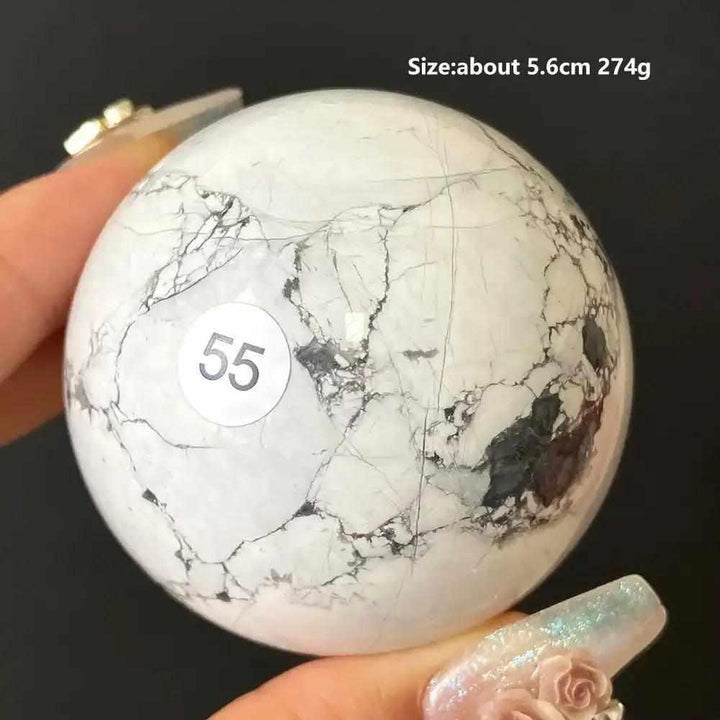 Polished Howlite Sphere 55, a creamy white calming stone with gray veining, 5.6cm, perfect for Crown Chakra meditation.