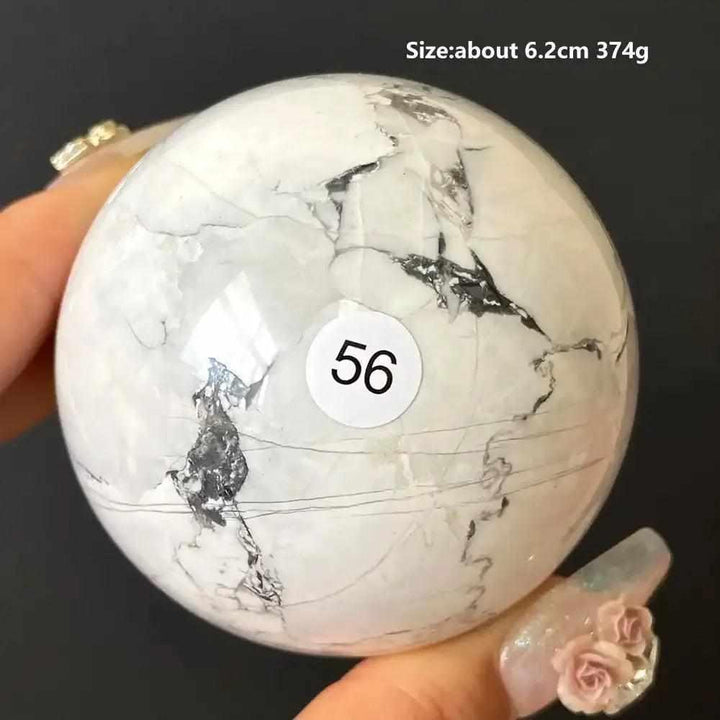 Polished 6.2cm Howlite sphere number 56, featuring creamy white stone with delicate gray veining for calm and balance.