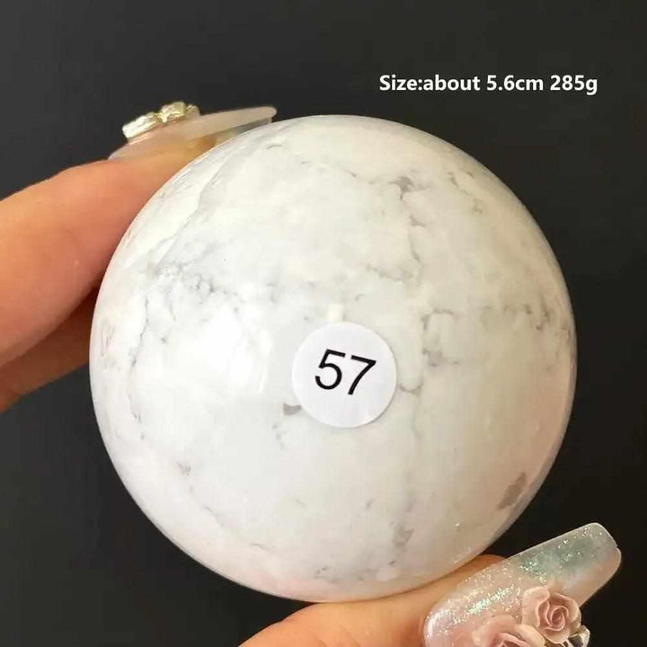 Polished Howlite sphere number 57, a creamy white stone with delicate gray veining for calming Crown Chakra meditation.