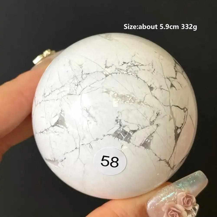 Polished 5.9cm Howlite sphere, style 58, featuring creamy white stone with delicate gray veining for calm and balance.