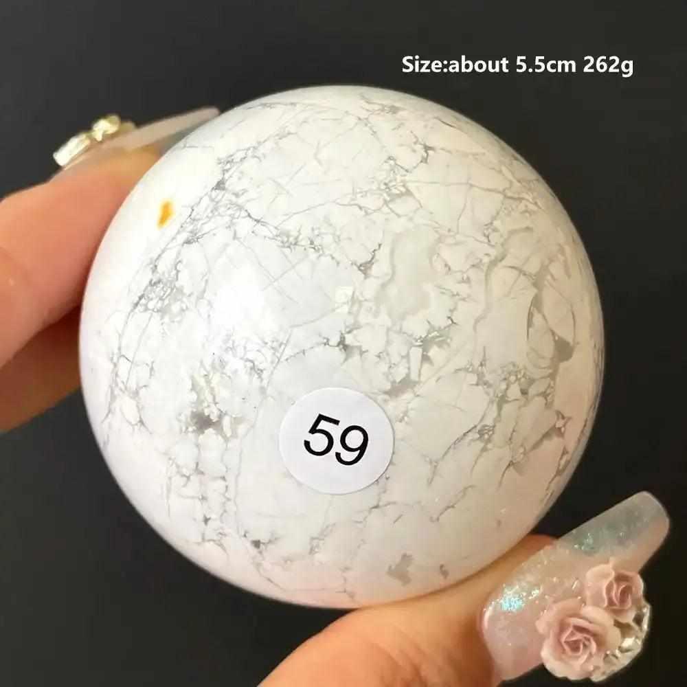 Polished Howlite sphere 59, a creamy white stone with delicate gray veining for Crown Chakra balance and calm meditation.