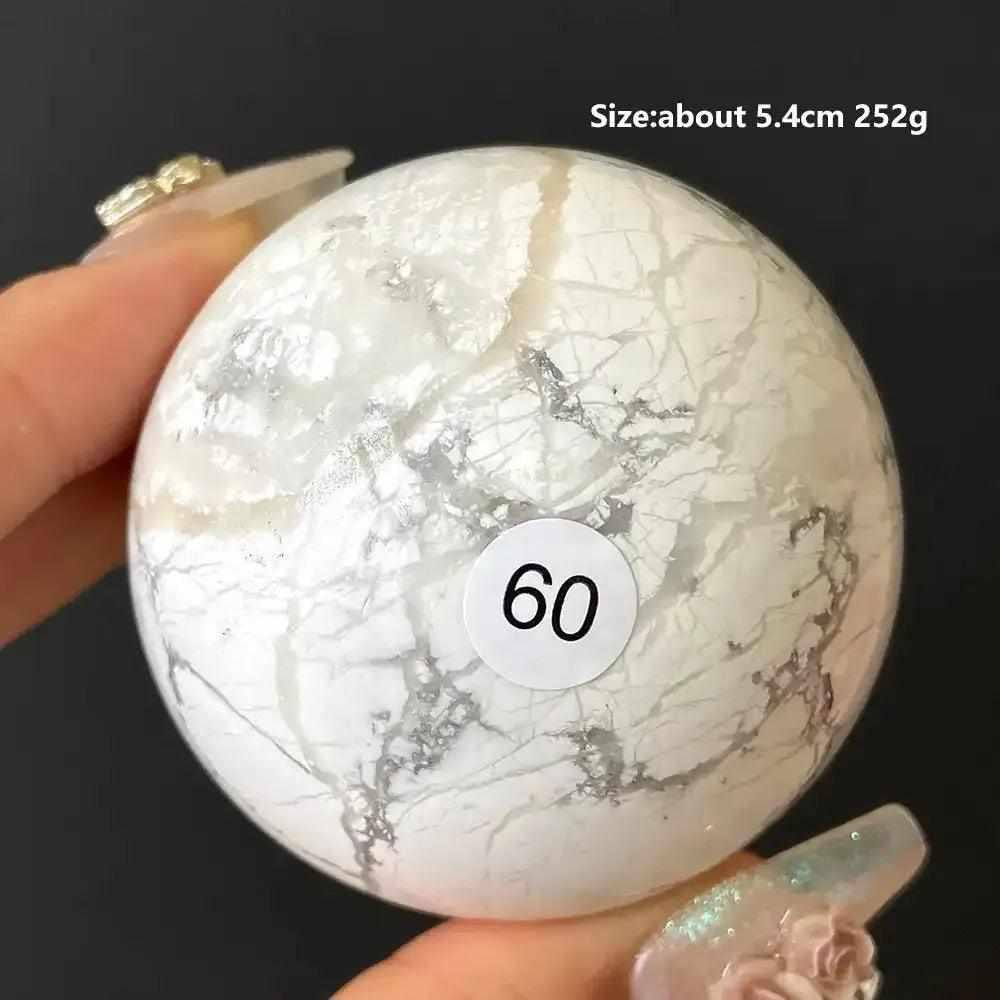 Polished Howlite sphere number 60, featuring creamy white stone with delicate gray veining for calm and Crown Chakra balance.