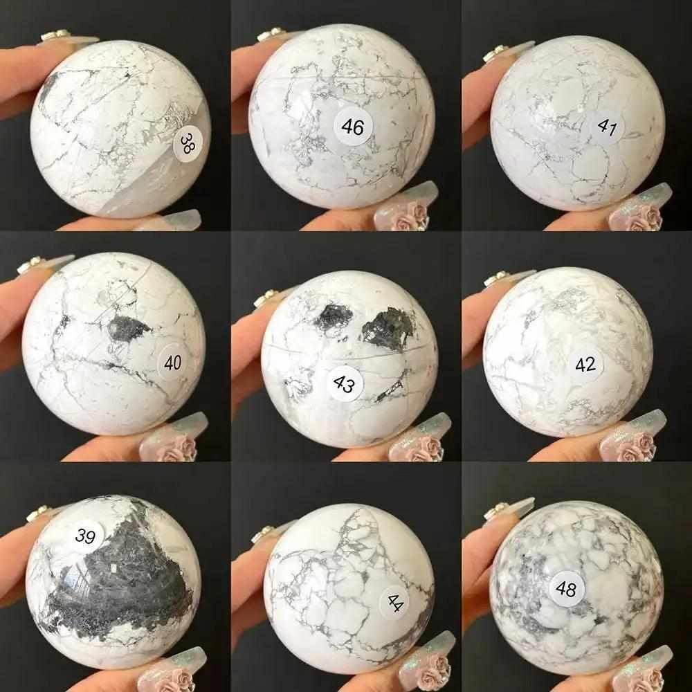Polished Howlite spheres in creamy white with gray veining, numbered for selection to promote calm and Crown Chakra balance.