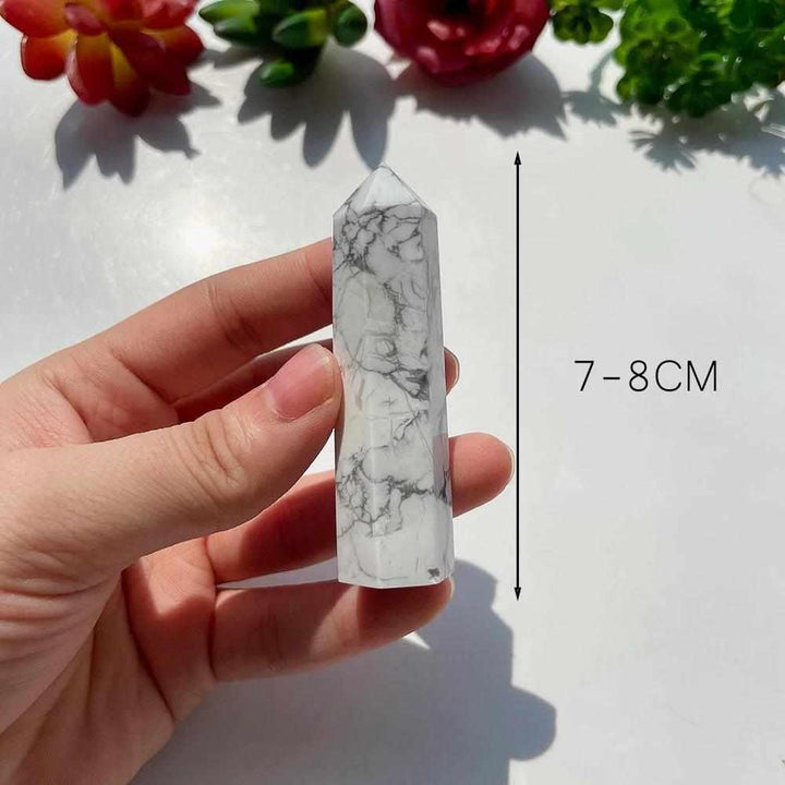 Polished white Howlite tower point with gray veining, a calming crystal for the Crown Chakra, 7-8cm tall.